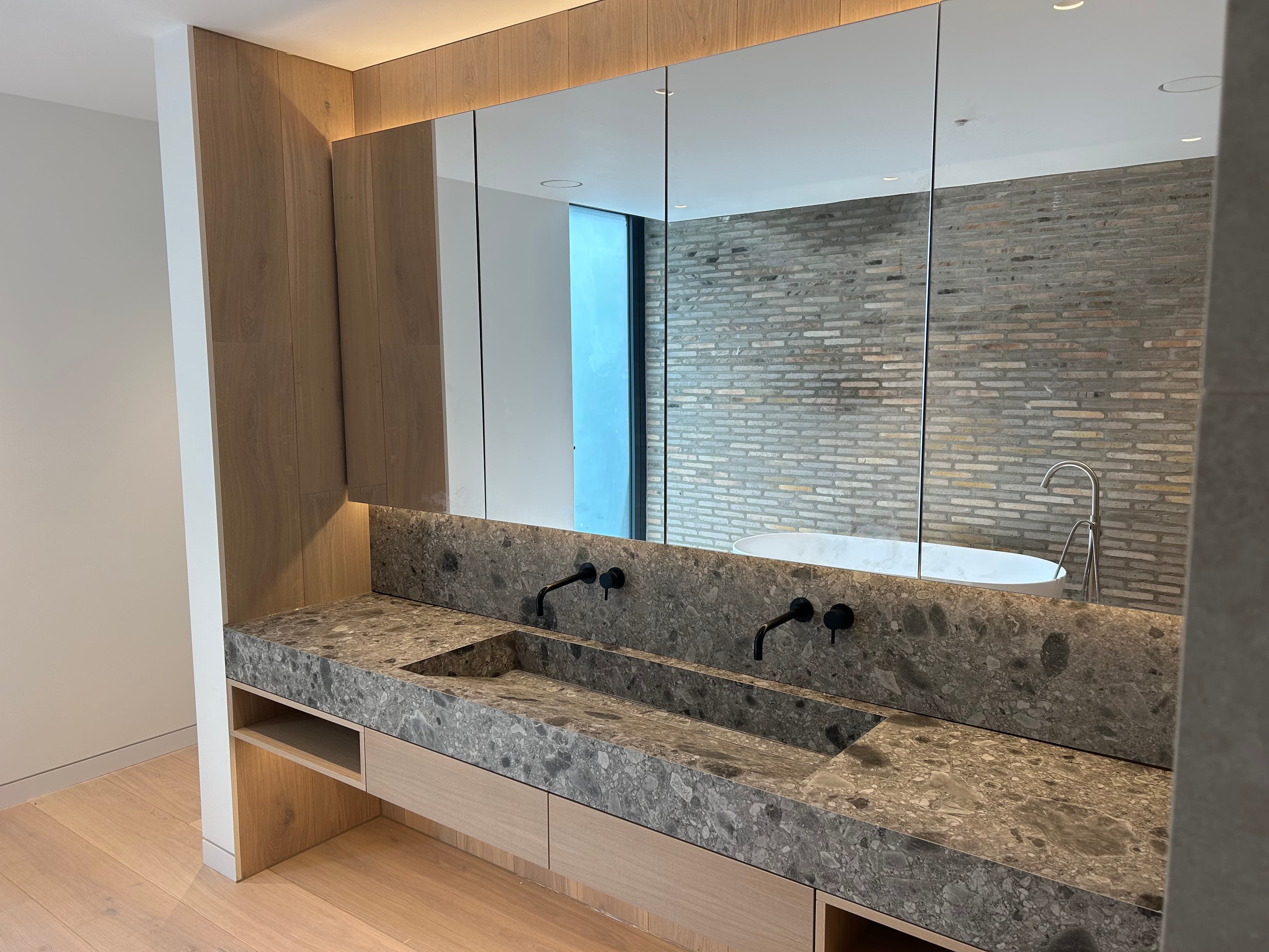 Walk-in shower lined in large-format stone